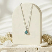 Silver Aria necklace with aqua faceted glass triangle pendant, March birthstone jewelry
