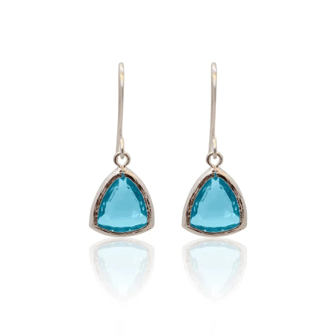 Pair of earrings with blue teardrop-shaped gemstones on a white background