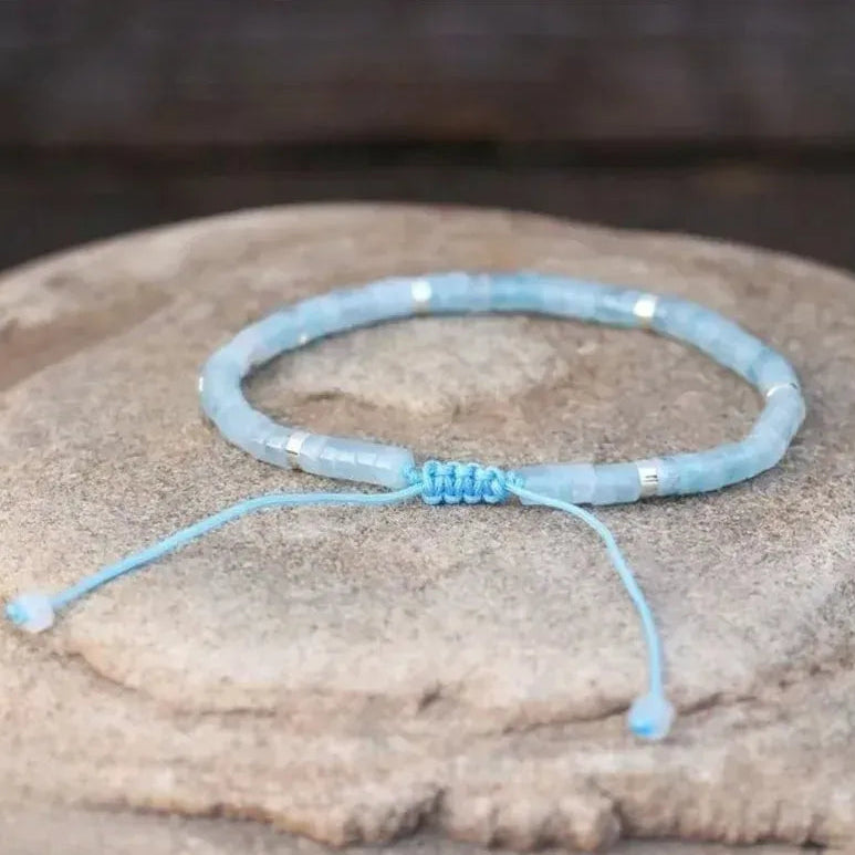 Light blue beaded bracelet on a stone surface