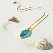 Necklace with a blue pendant on a white background