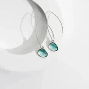Teal earrings on a white background