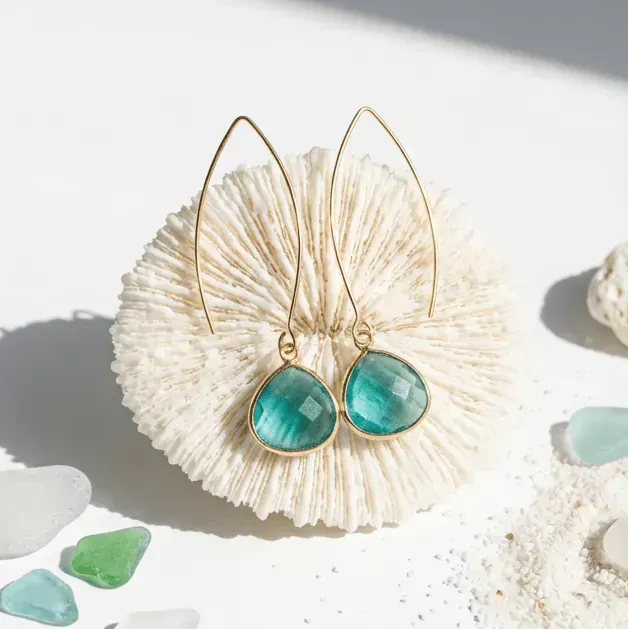 Jewelry set with teal stones on a shell, labeled 'March Birthstone' by Mystic Soul Jewelry.