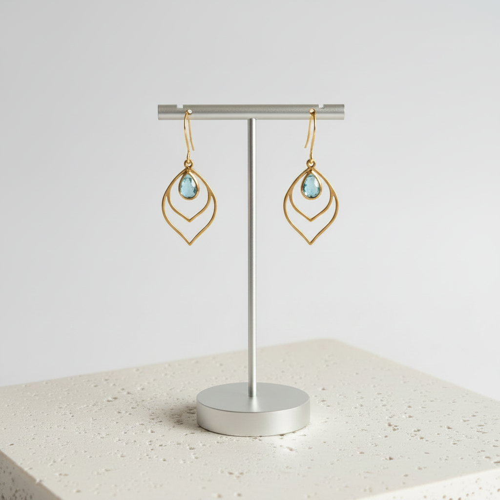 Aqua blue faceted glass teardrop earrings in gold, shown hanging