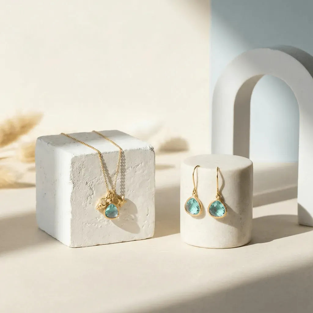 Gold jewelry with turquoise stones on a white surface
