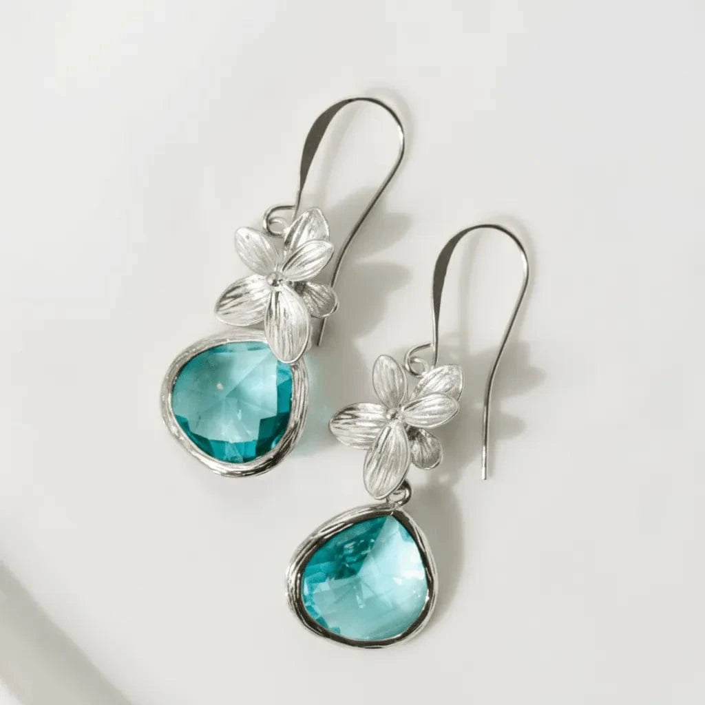 Silver earrings with turquoise stones on a white background