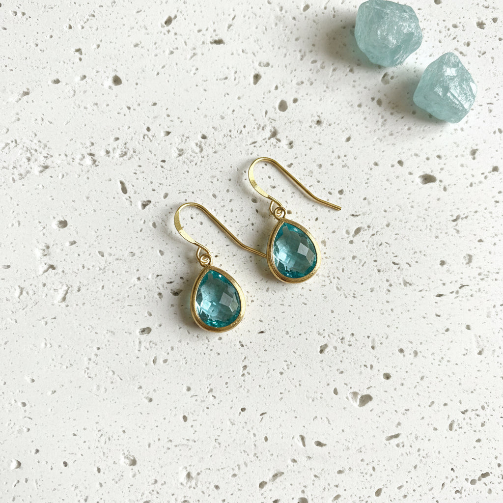 Aqua blue faceted glass drop earrings in gold plated brass