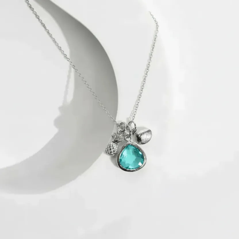 Silver necklace with a turquoise pendant on a white background