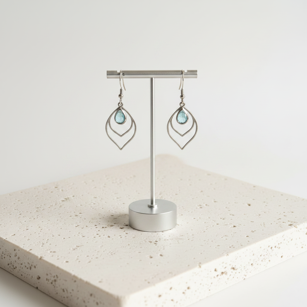 Aqua blue faceted glass teardrop earrings in silver, shown hanging