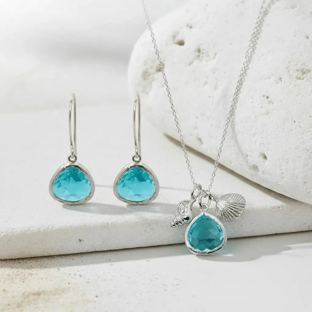 Jewelry set with turquoise stones on a white stone background