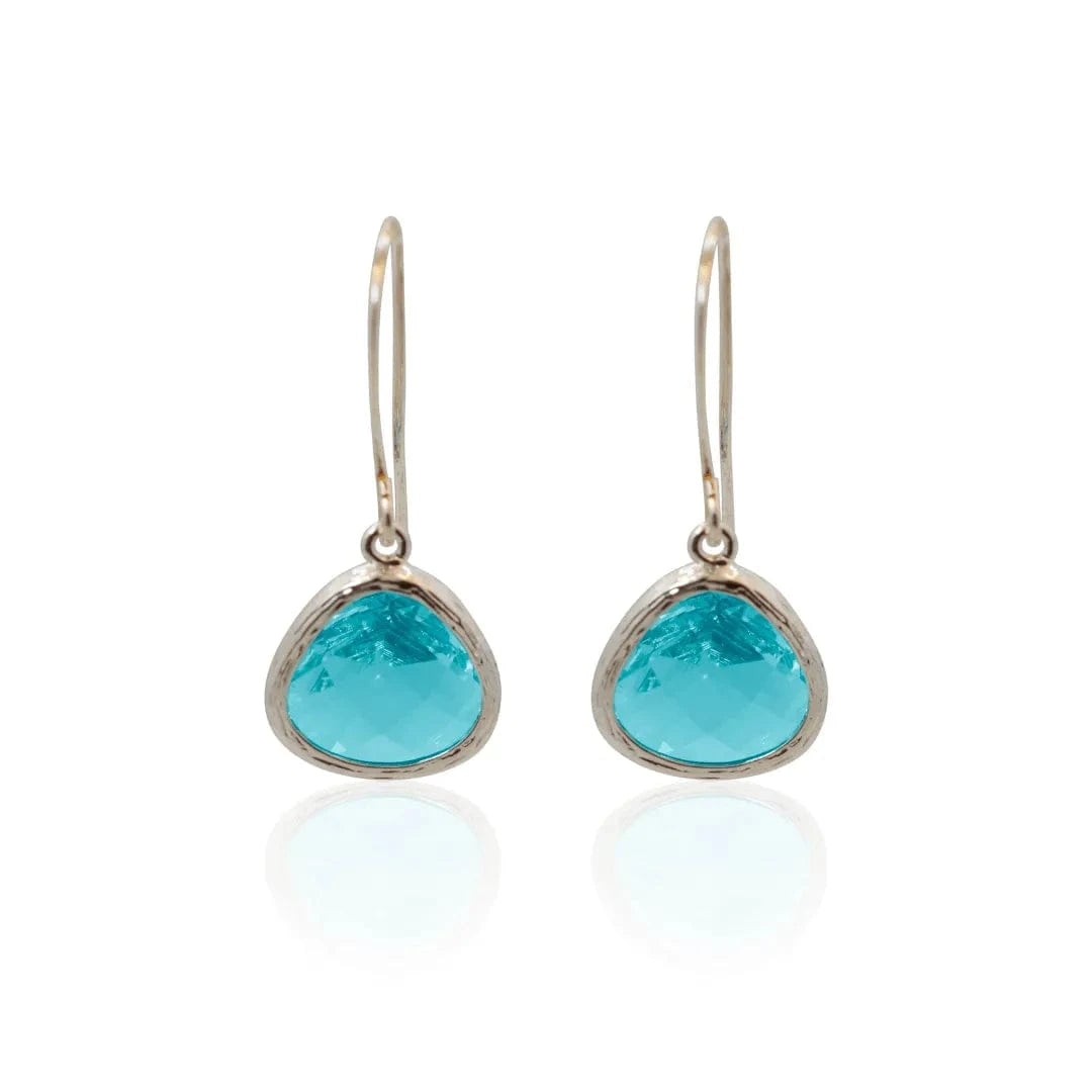 Turquoise teardrop earrings with gold accents on a white background