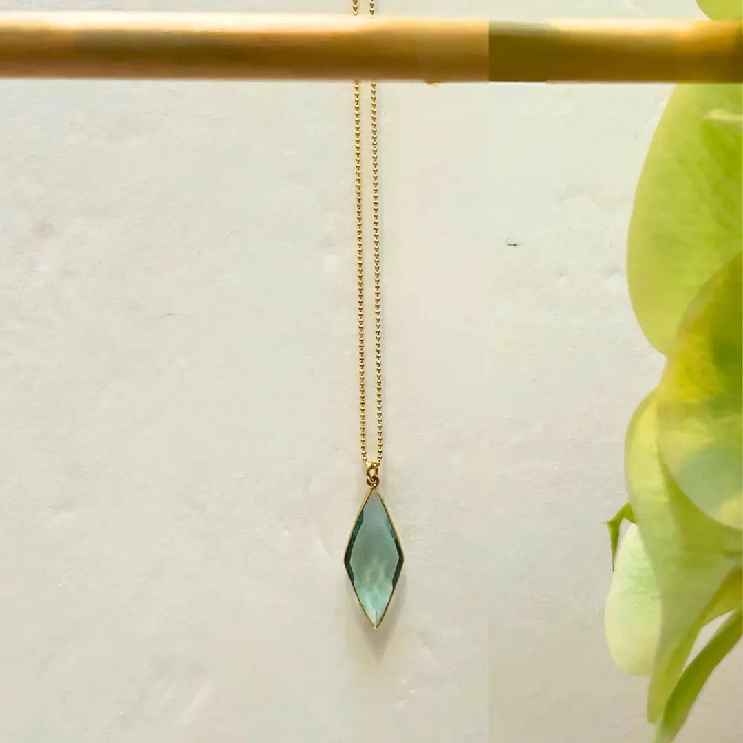 Necklace with a green pendant on a white background