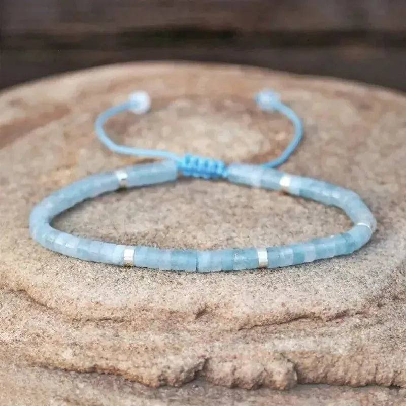 Blue beaded bracelet on a textured surface