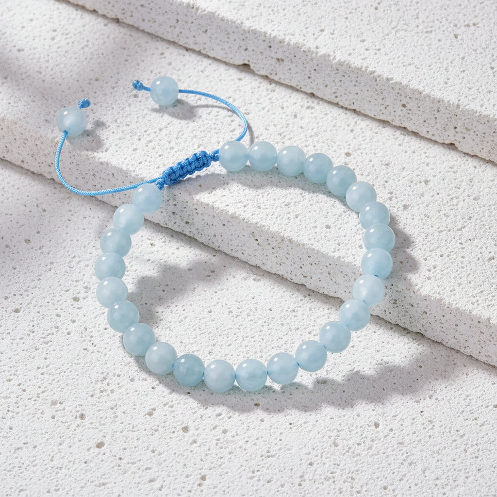 Aquamarine bracelet on a card with text on a wooden surface