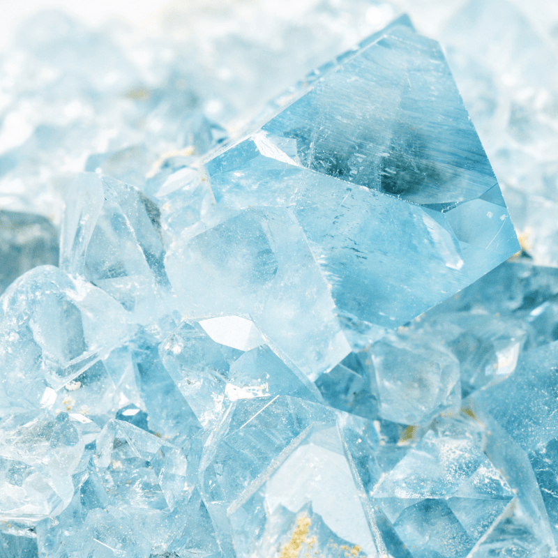 a photo of raw aquamarine blue gemstone crystals