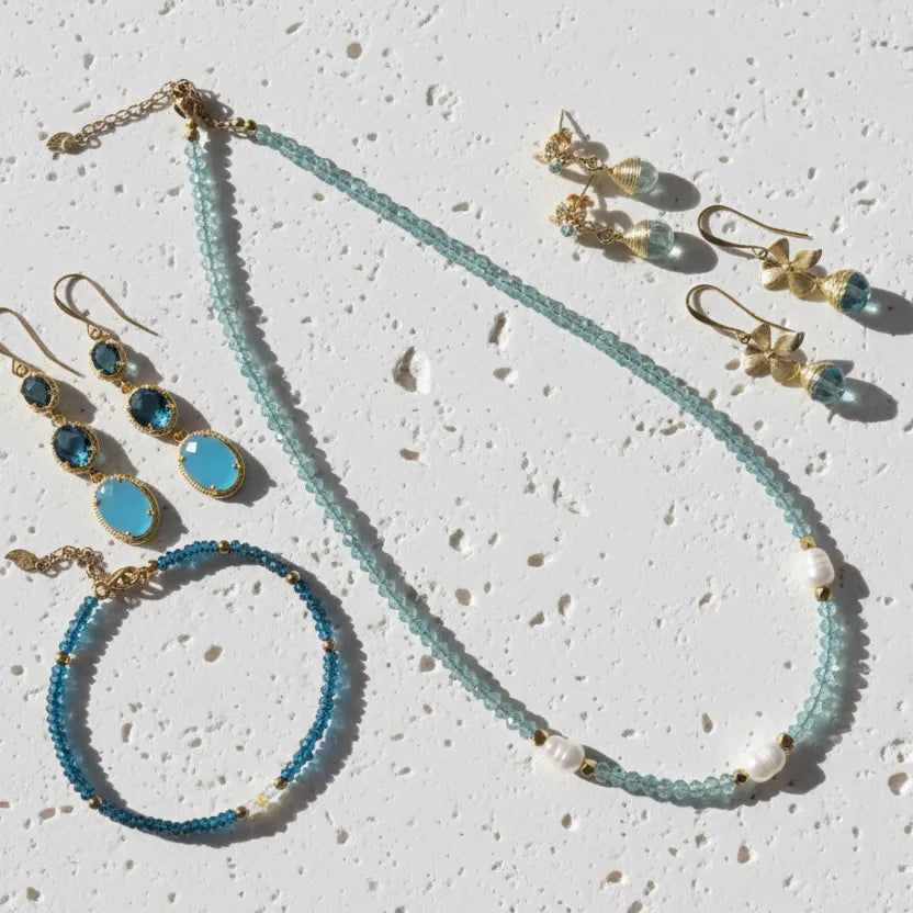 A jewelry set featuring a light blue 