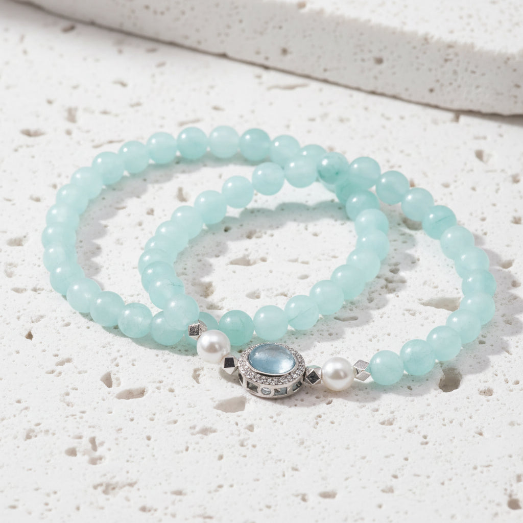Light blue beaded bracelet with a silver clasp on a white background