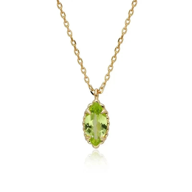 Gold necklace with a green gemstone pendant on a white background