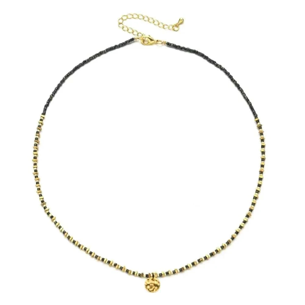 Necklace with black and gold beads on a white background