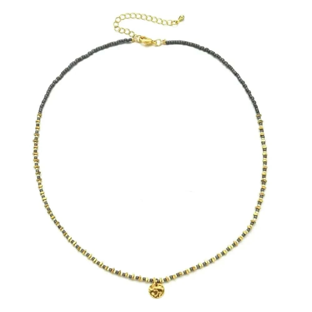 Necklace with black and gold beads on a white background