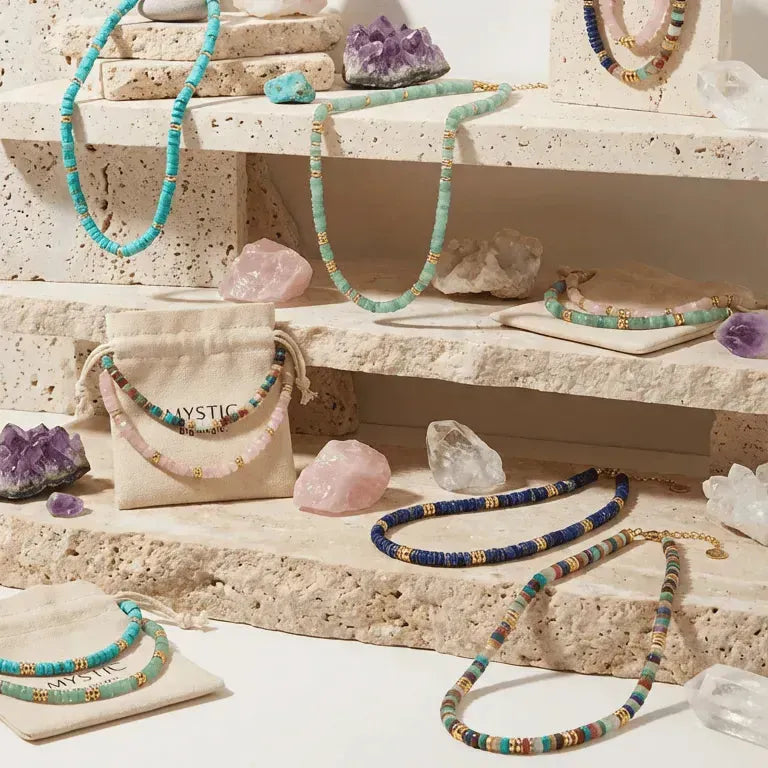 Jewelry and crystals on a stone shelf with 'Mystic Holiday Gift Guide' text.