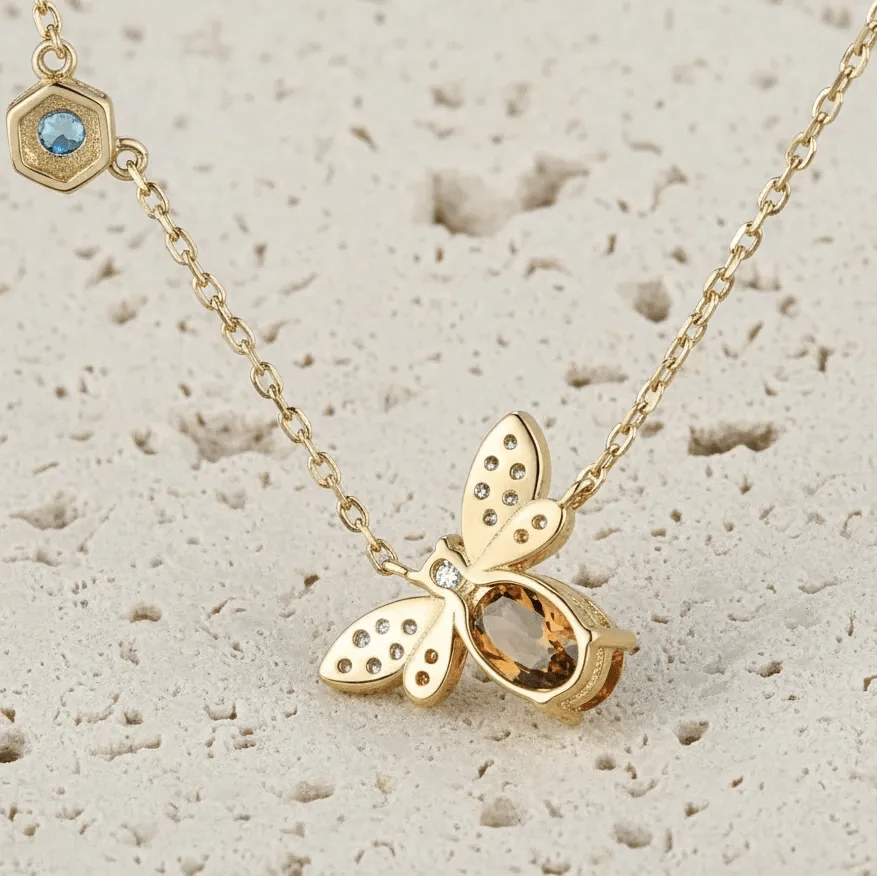 Gold butterfly necklace with gemstones on a light background