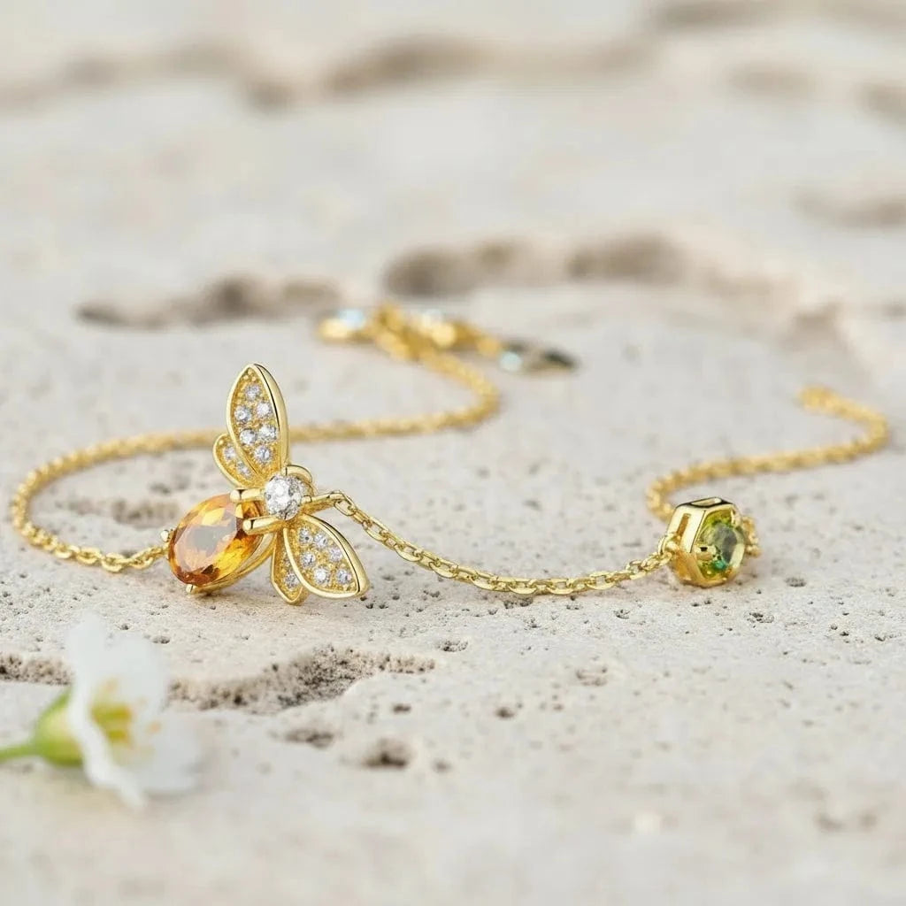 Gold bracelet with gemstones on a light background