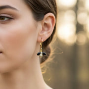 Gold and black bee dangle earring worn on the ear — spirit animal jewelry