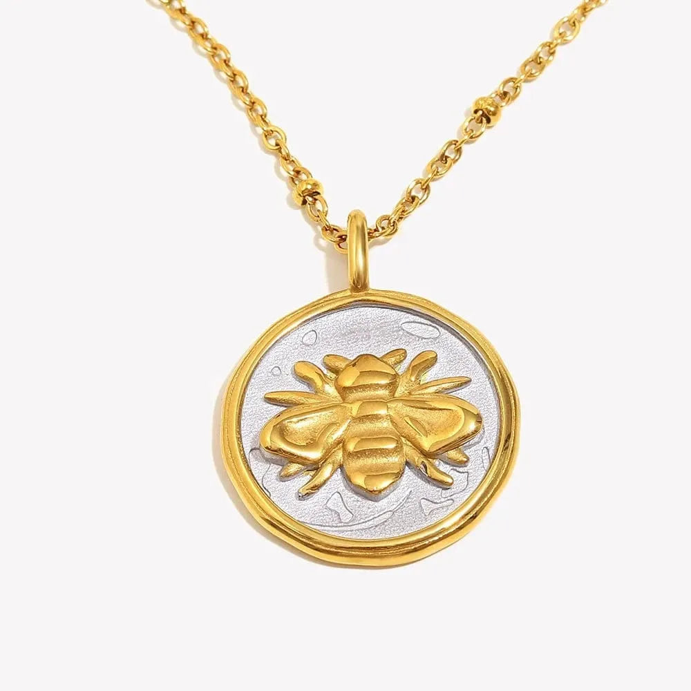 Gold and silver bee pendant necklace on a white background