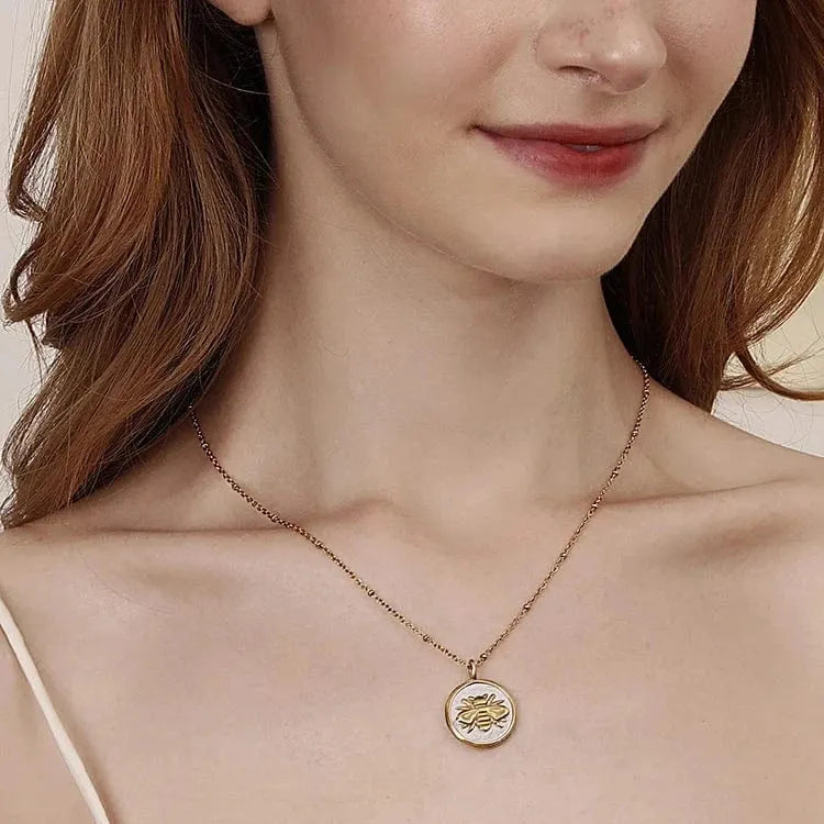 Necklace with a circular pendant worn by a person