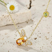 Butterfly-shaped necklace with gemstones  on limestone background