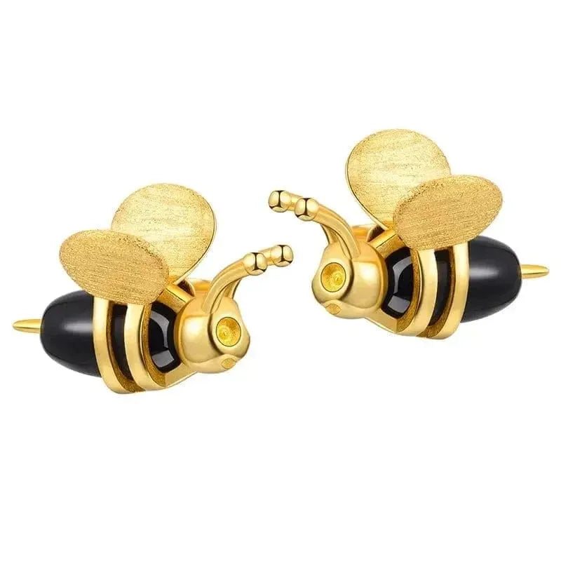 Gold and black bee-shaped earrings on a white background