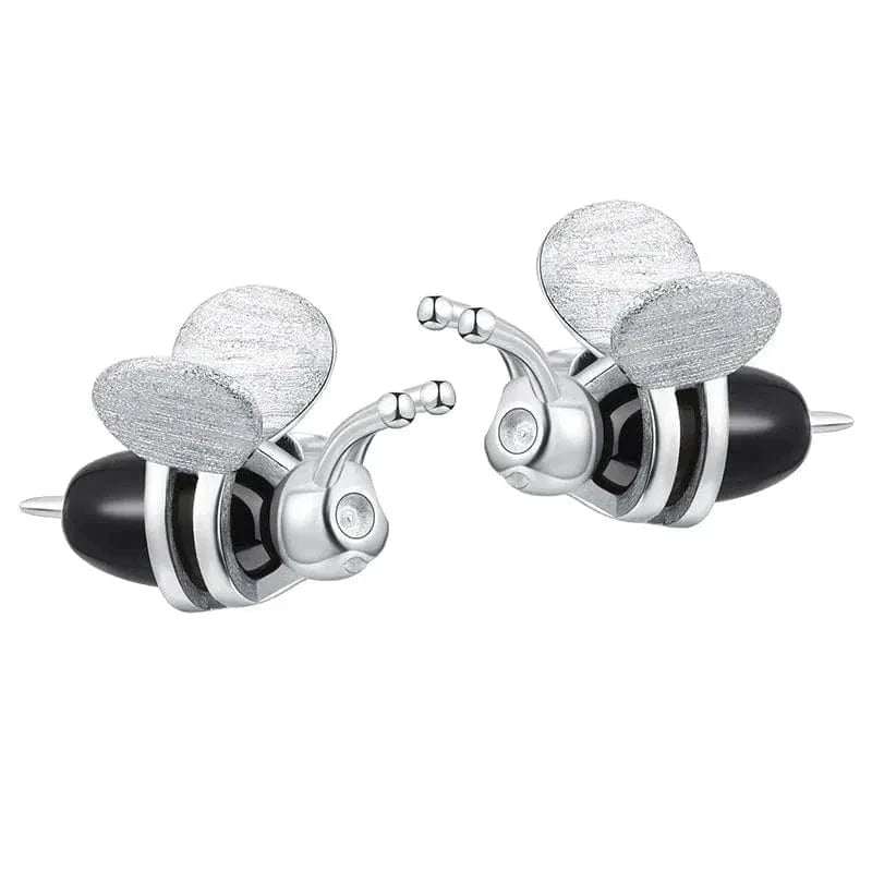 Pair of silver and black earrings on a white background