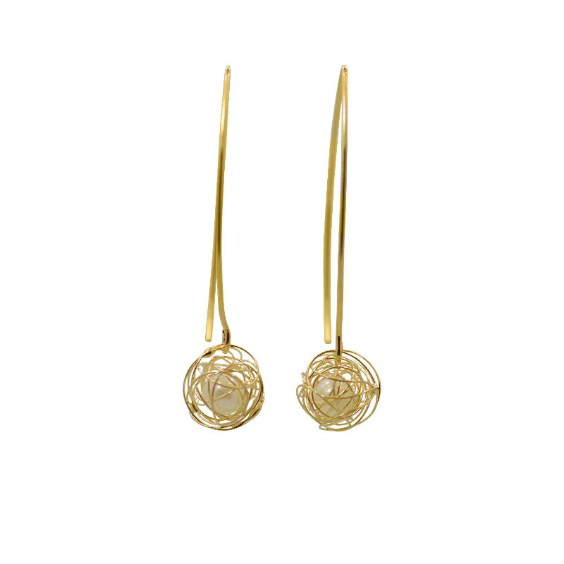Pair of gold earrings with intricate designs on a white background