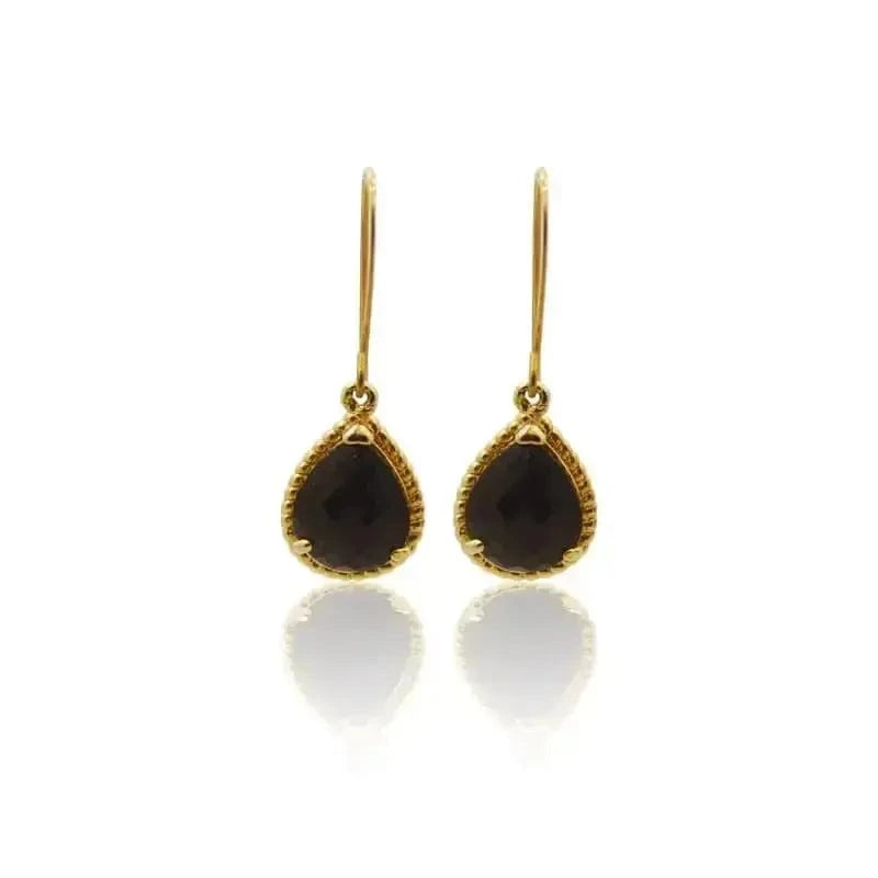 Elegant black earrings with gold accents, perfect for elevating any outfit. Classic best seller accessory.