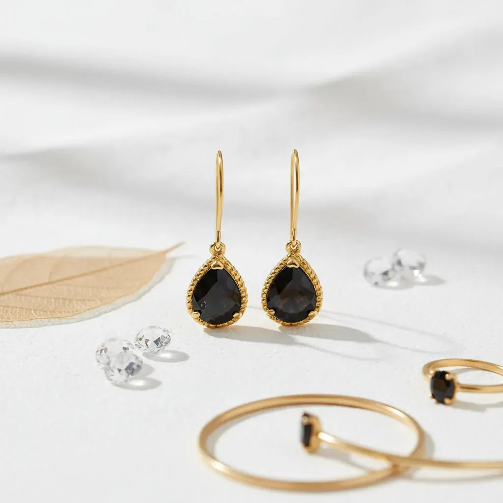 Elegant black earrings with gold accents, perfect for elevating any outfit. Classic best seller accessory.