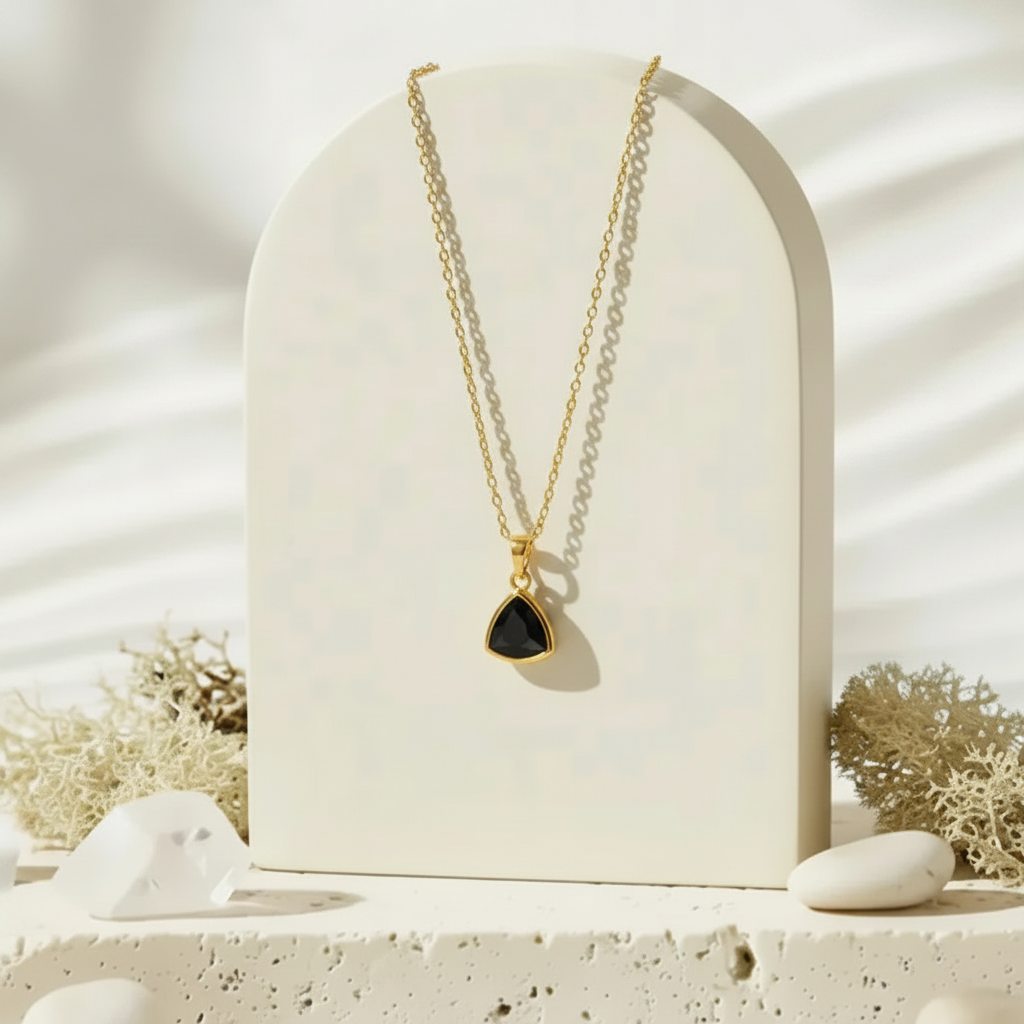 Gold Aria necklace with black faceted glass triangle pendant