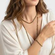 Woman wearing black beaded bracelet and necklace set, bohemian layering jewelry