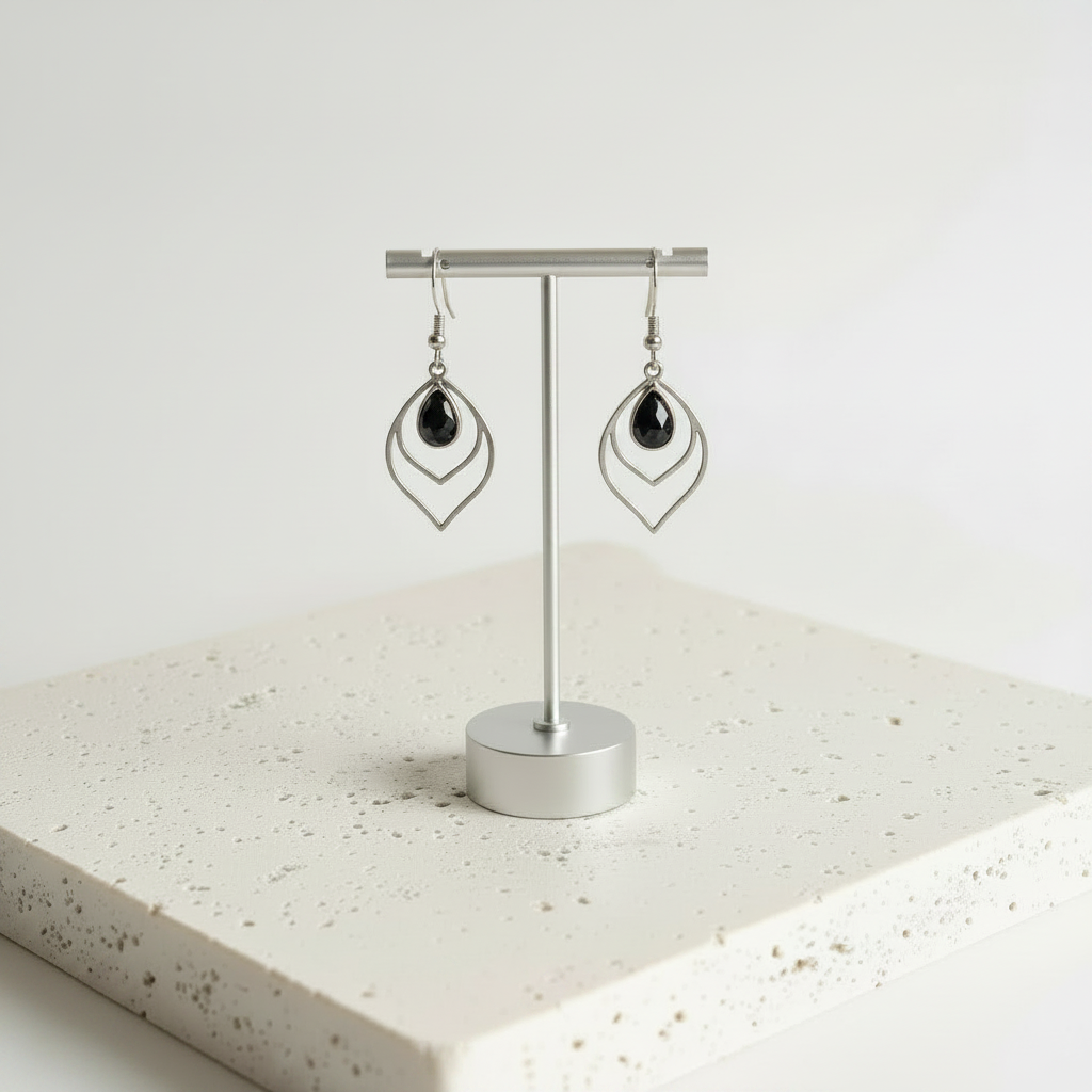 Black faceted glass teardrop earrings in silver, shown hanging