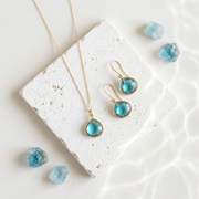 Faceted blue topaz pear necklace and matching earrings in gold plate, December birthstone set