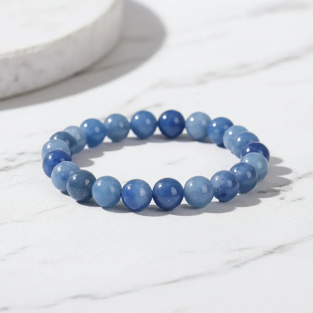 Blue beaded bracelet on a white marble surface