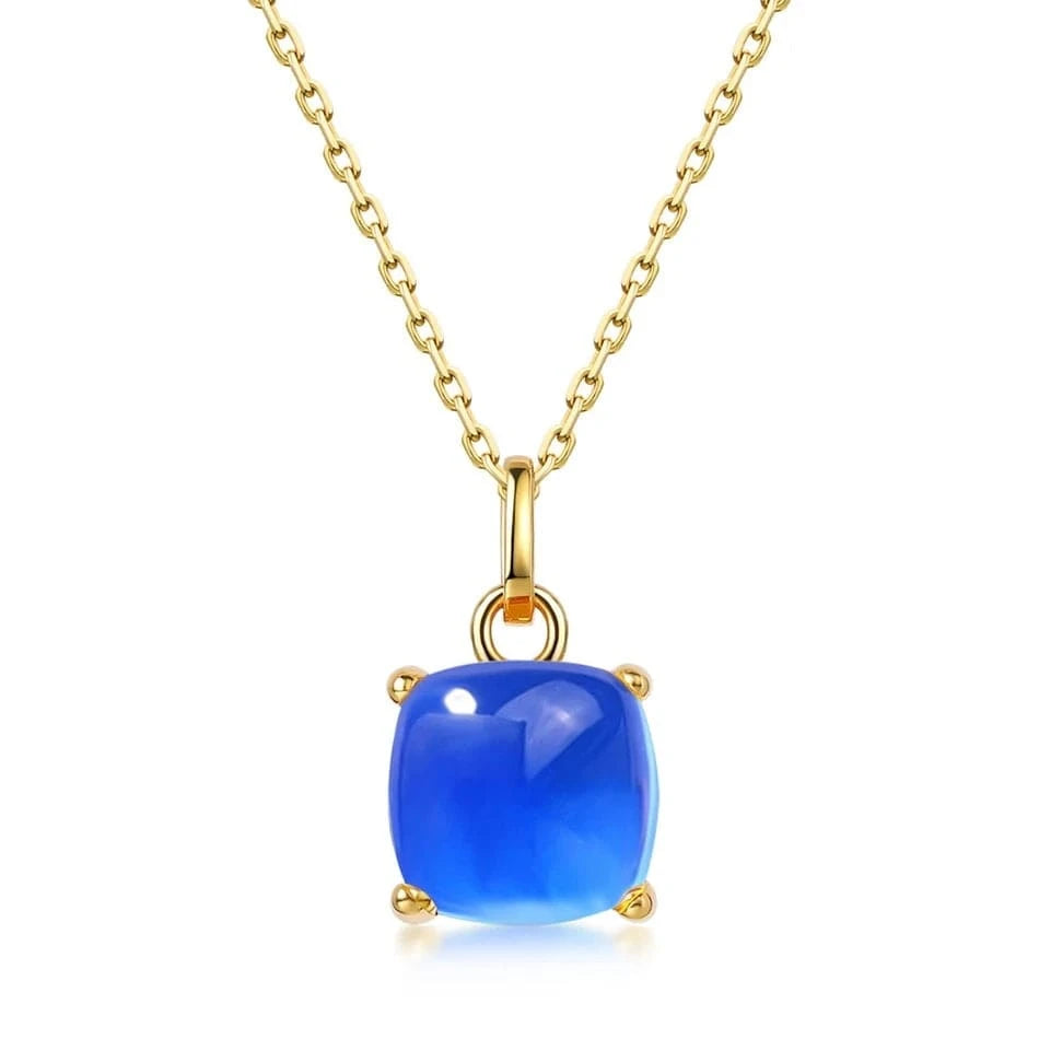 Gold necklace with a blue pendant on a white background
