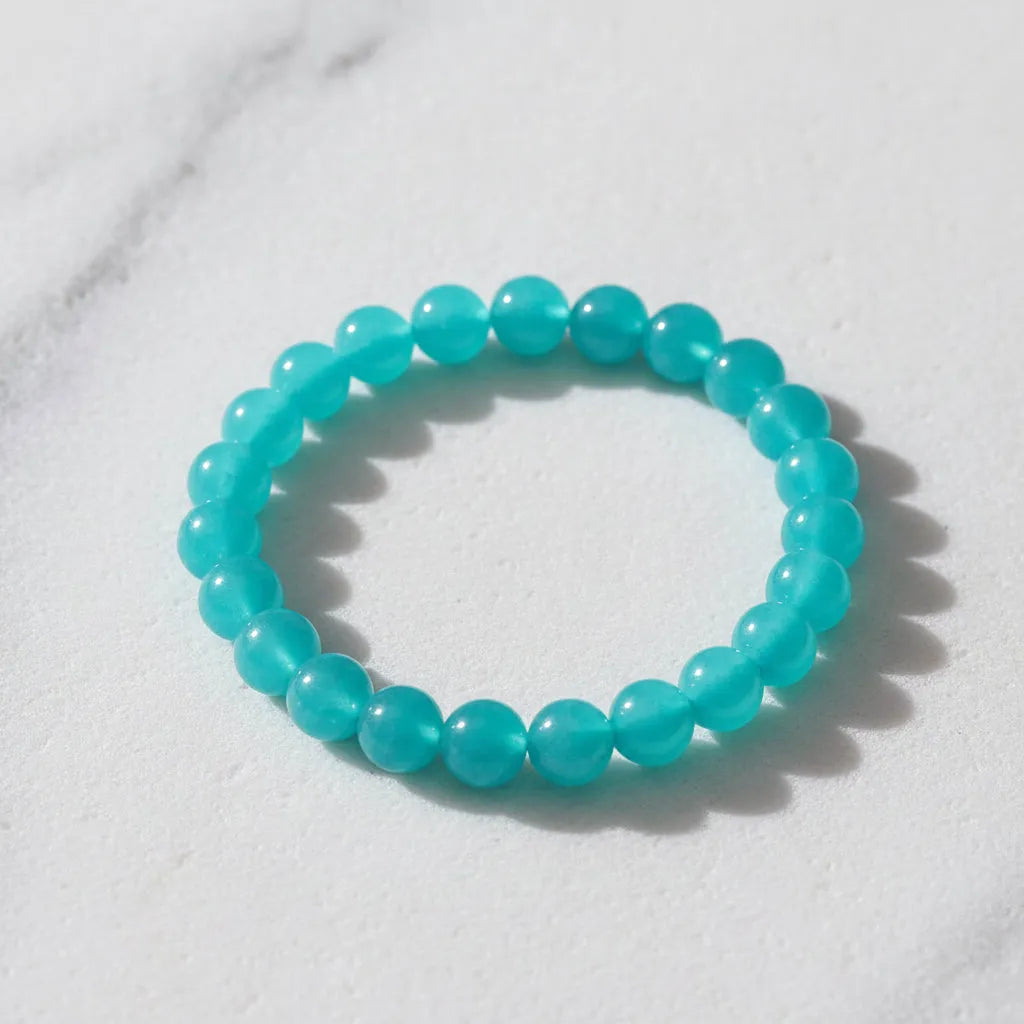 Turquoise beaded bracelet on a white marble surface