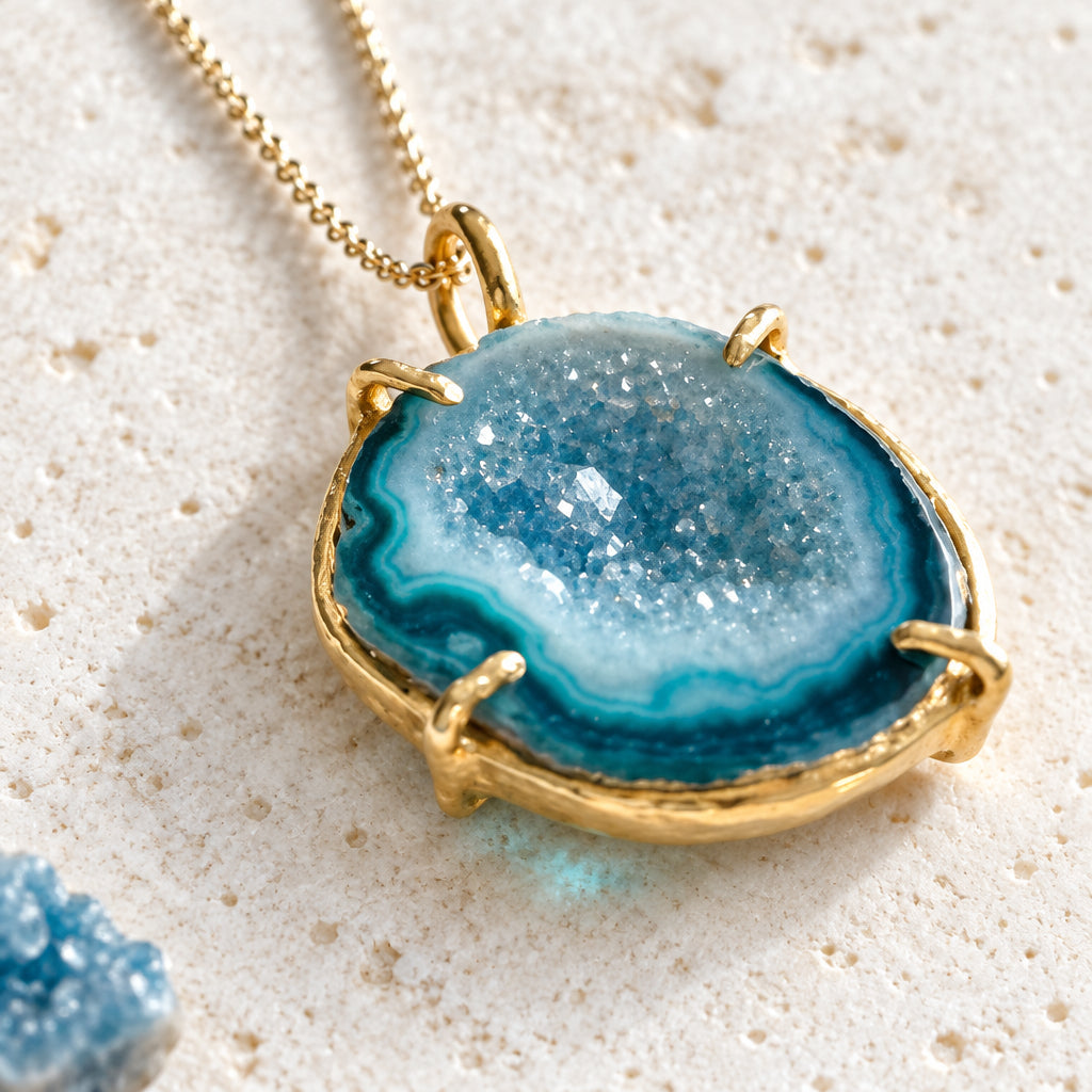 Close-up of the blue druzy agate's sparkling crystal face and gold-plated bezel edge