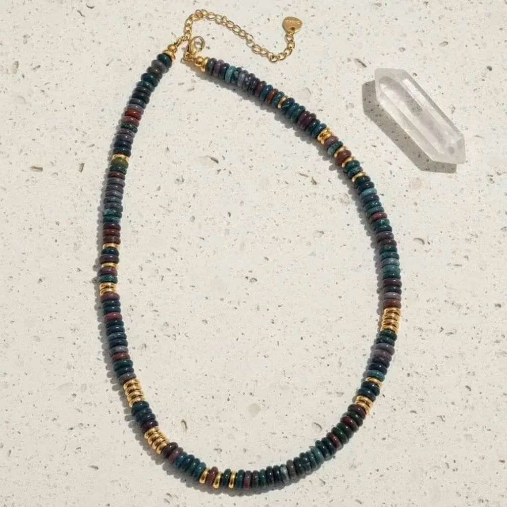 Necklace with multicolored beads and gold accents on a white background
