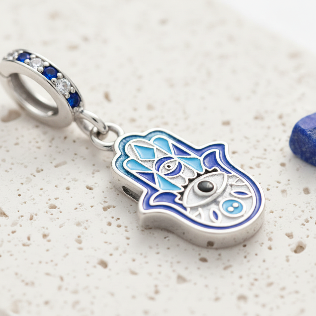 Blue hamsa hand pendant, sterling silver with blue zircon detail — symbol jewellery for protection