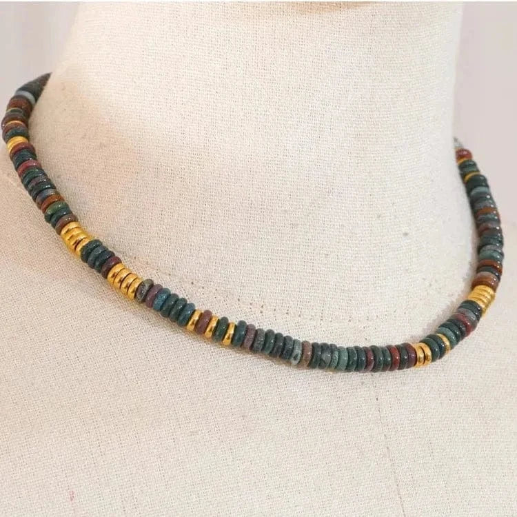 Necklace with multicolored beads on a mannequin bust.