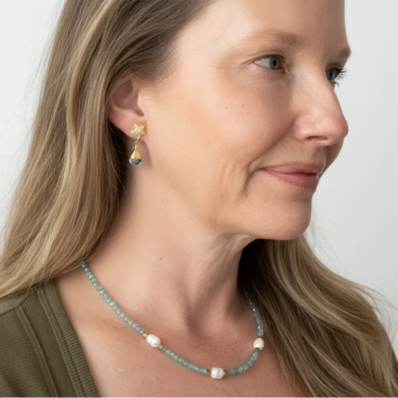 Andrea wearing aquamarine potato pearl necklace and gold orchid drop earrings — one-of-a-kind crystal jewelry for calm