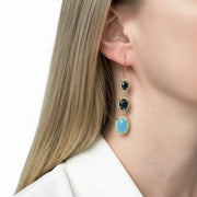 Woman wearing blue chalcedony and Swiss blue topaz drop earrings in gold — 48mm graduated column