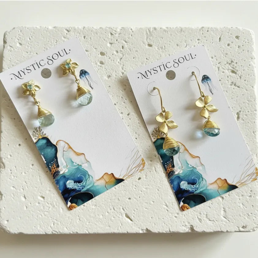 gold blue topaz orchid drop earrings on branded cards — one-of-a-kind crystal jewelry for calm