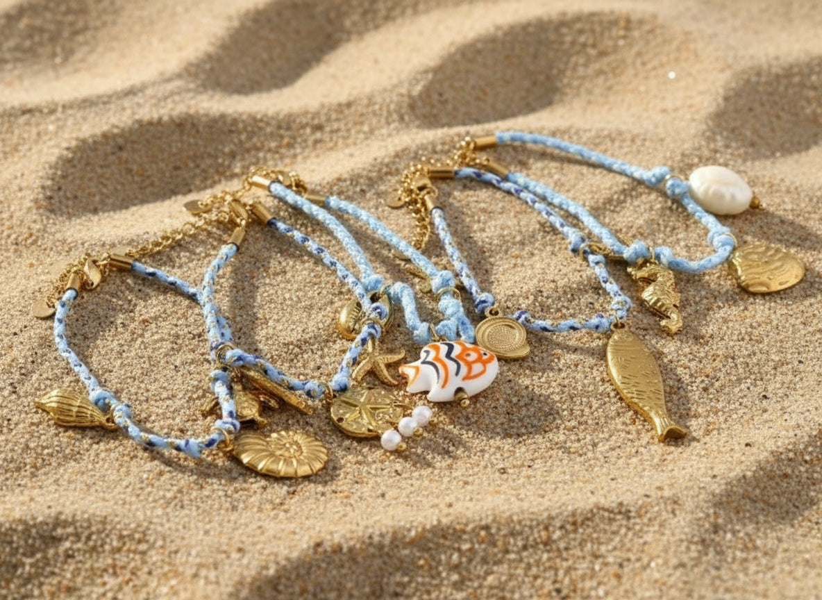 Set of bracelets with gold charms on a white background